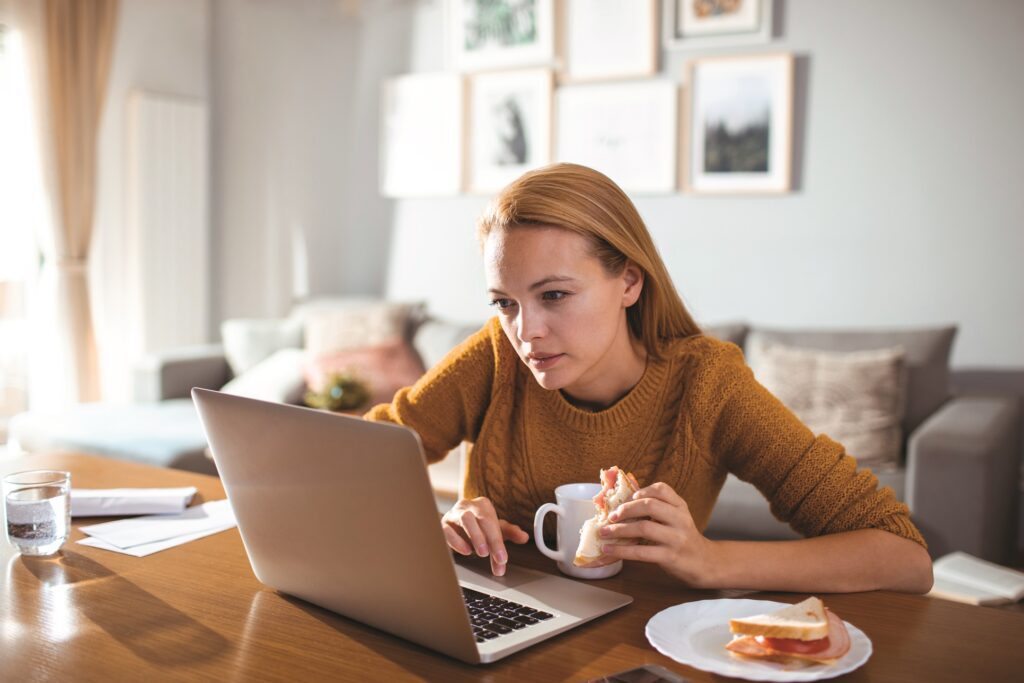 Close up of a young woman using her laptop at home to research Egg freezing facts